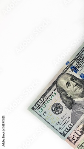 Fotografie Three United States currency notes in denominations of 20 dollar bill, 50 dollar bill, 100 dollar bill, neatly stacked diagonally on a white background