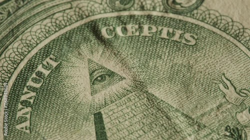 Close up of the Eye of Providence on United States dollar bill. Illuminati and conspiracy theories concept