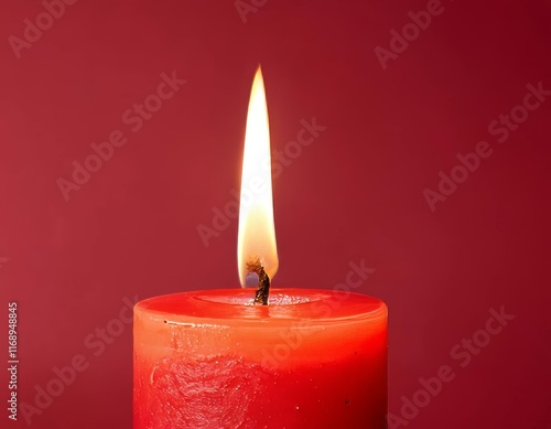 A close-up of a lit candle with a red background photo