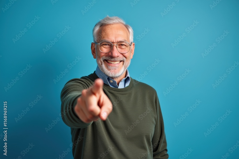 Fototapeta premium Happy Senior Man Pointing Forward Smiling Optimistically Perfect for Inspirational and Motivational Campaigns