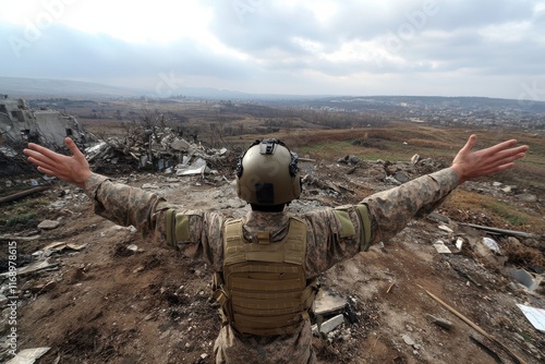 A soldier wearing tactical gear stands amidst a desolate landscape, arms outstretched, symbolizing resilience and strength in the face of destruction and chaos. photo