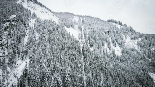 Cloudy winter Alpine aerial dronview (Austria) with fantastic pattern-reflection on the snow surface.  photo