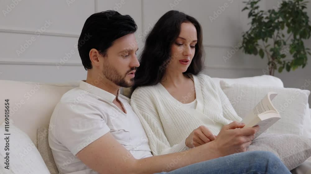 Couple enjoys quiet afternoon reading together on comfortable sofa Couple enjoys quiet afternoon reading together on comfortable sofa