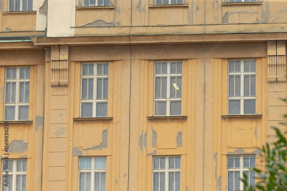 Historic building in an urban setting, old wall, highlighting its unique windows and architectural features Historic building in an urban setting, old wall, highlighting its unique windows and architectural features