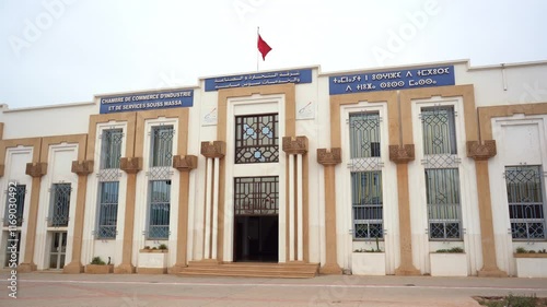 Chamber of Commerce, Industry and Services, Agadir
on the signs is written: Chamber of Commerce, Industry and Services Souss Massa
on the left in French
in the middle in Arabic
on the right in Amazigh