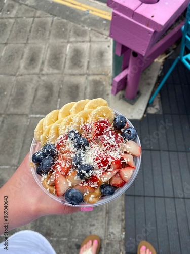 Acai smoothie bowl being held by hand