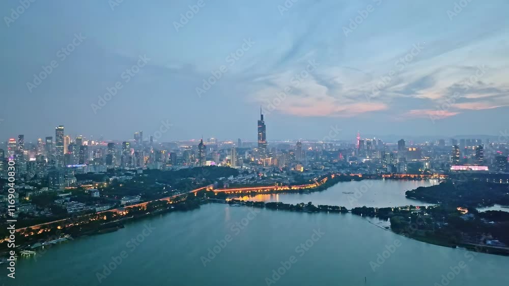 Stunning skyline view of Nanjing at twilight with city lights and reflections on the lake Stunning skyline view of Nanjing at twilight with city lights and reflections on the lake