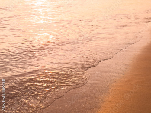 Water and sand at the beach in sunset time photo