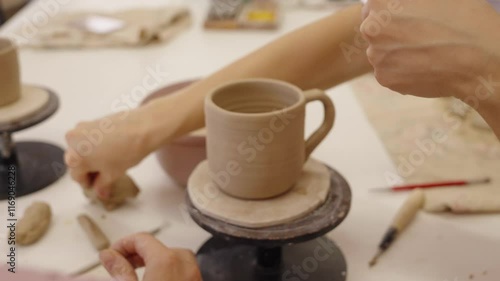 Crafting a clay mug at a local pottery studio in the afternoon