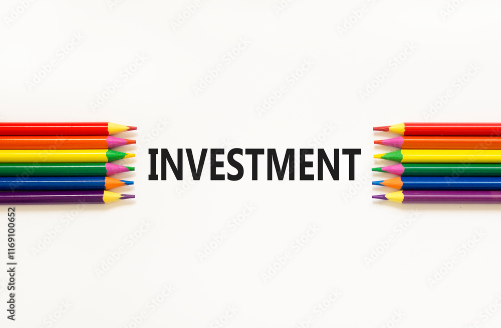 Fototapeta premium Investment symbol. Concept word Investment on beautiful white paper. Beautiful white paper background. Beautiful colored pencils. Business investment concept. Copy space.
