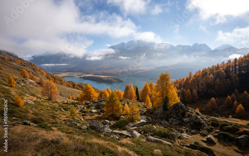 View over the upper Engadine, Graubuenden, Switzerland. Lake silsersee with Bernina Group in the background. Autumn season photo