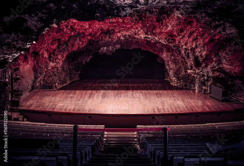Underground Cave Theater with Wooden Stage and Dramatic Lighting