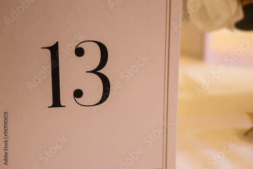 close up of black number 13 thirteen on a white card with copy space photo