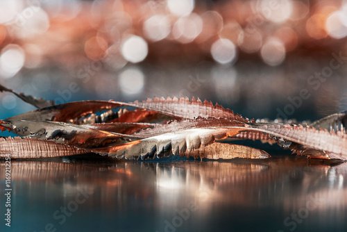 Copper filings, shavings, and scraps on a shiny industrial surface up close, a raw material for the non-ferrous and colored metals industry photo