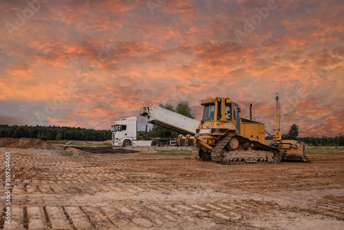 Wallpaper Mural Crawler dozer an dump at a construction site in a quarry. Powerful modern equipment for earthworks. Construction site. Heavy bulldozer and dump or lorry at work. Building machines. Torontodigital.ca