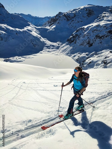 Wallpaper Mural Panorama view in the Alps. Young woman on a ski tour on the ascent to the Etscherzapfenn in the background Lake Murgsee in the Glarus region. Ski mountaineering in the beautiful Swiss mountains Torontodigital.ca