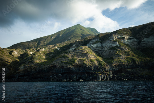 Sailing towards Pollara, famous sunset place in Salina Island, Sicily. Admiring the island's rocks from the sea. photo