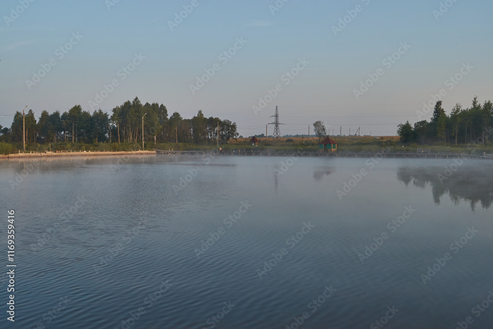 Naklejka premium Sunrise over the lake. Fishing on the lake. Reflection in water.