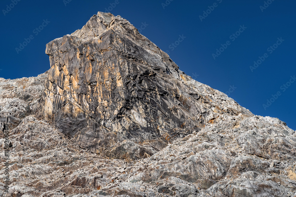 rocky stop in a canyoned valley and in the cold of an alpine landscape after winter with the light on the mountain rocks. rocky stop in a canyoned valley and in the cold of an alpine landscape after winter with the light on the mountain rocks.