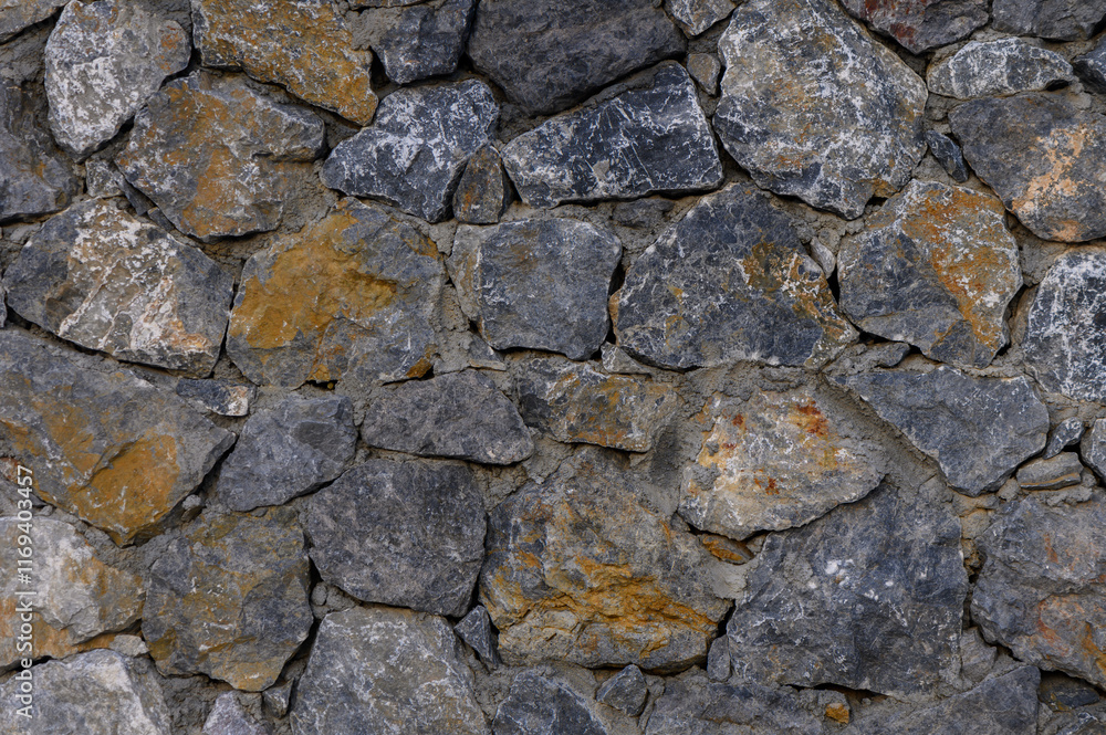 Beautifully textured stone wall showcasing natural patterns and earthy tones Beautifully textured stone wall showcasing natural patterns and earthy tones