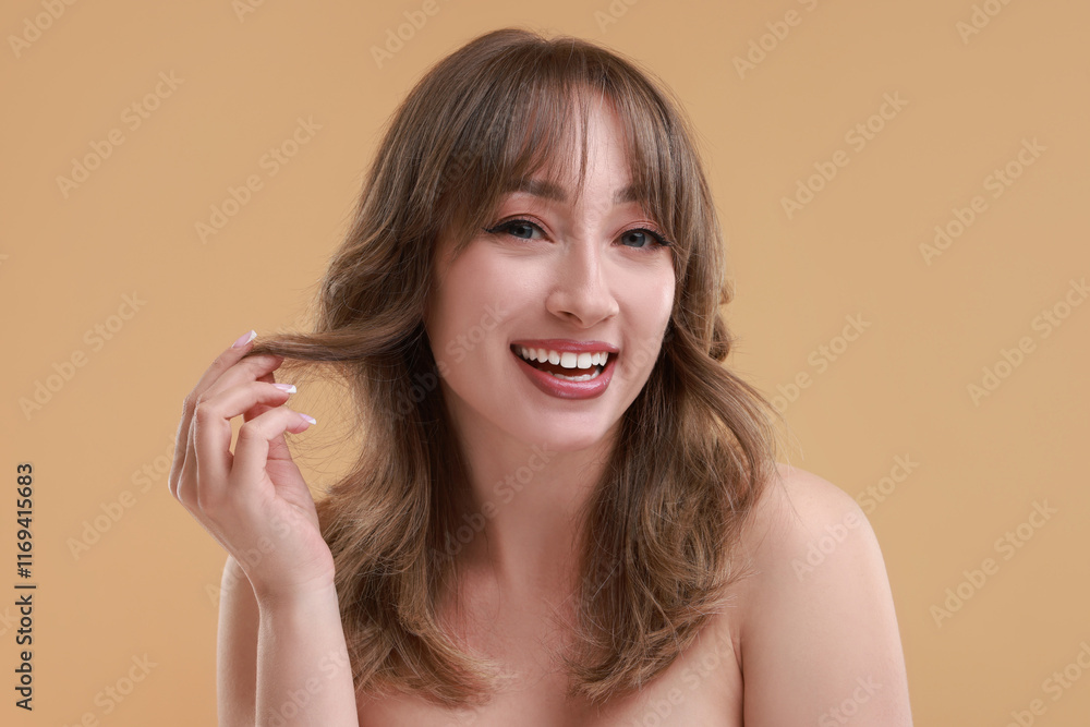 Attractive woman with stylish haircut on beige background