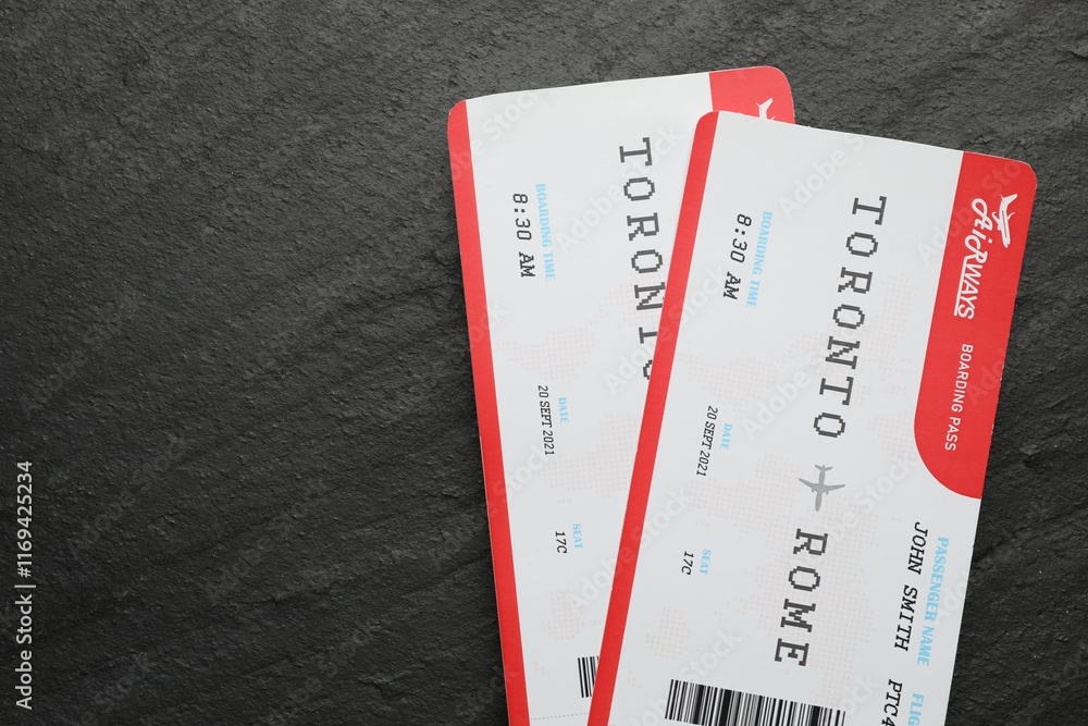 Travel agency. Flight tickets on dark textured table, top view. Space for text Travel agency. Flight tickets on dark textured table, top view. Space for text