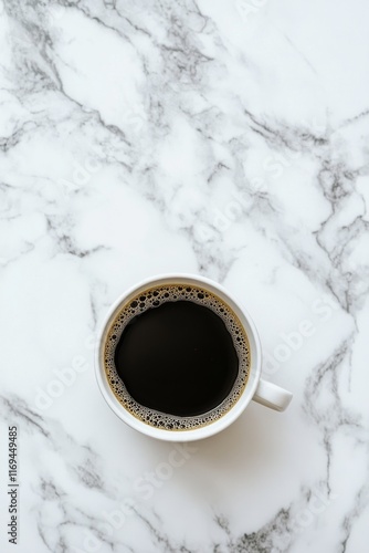 Freshly brewed coffee in a white cup resting on a marble countertop