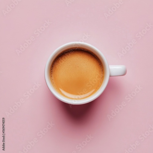 Freshly brewed coffee in a white cup on a soft pink background