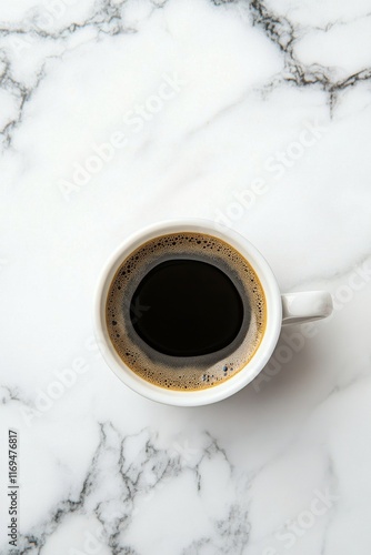 Freshly brewed coffee in a white cup resting on a marble countertop
