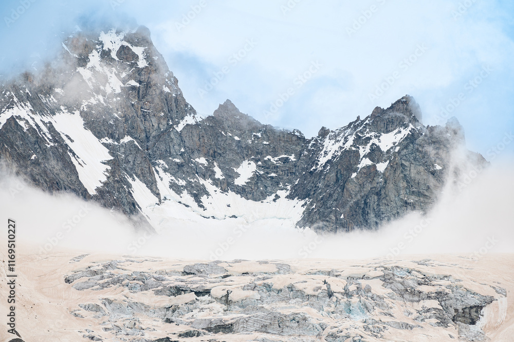 Obraz premium Silhouettes of mountain range with glacier during snowfall in the Alps. Mont Blanc massif. Weather. Climate change 