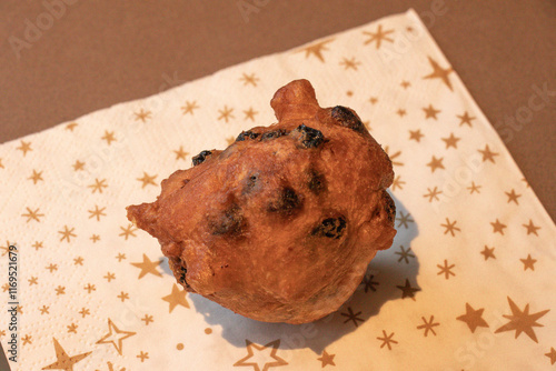 Oliebol fresh Dutch pastry on plate festive tissue. New years treat in the Netherlands. Happy New Year snack. photo