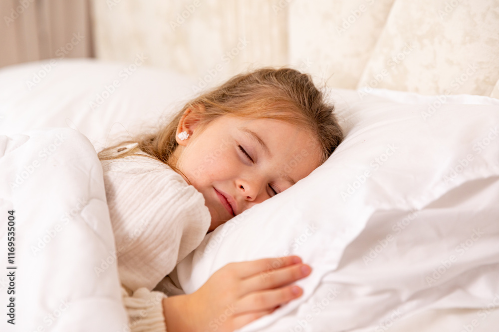 Top view cute little girl sleeping in bed. Little blonde girl sleeps sweetly in bed with white linen. space for text. healthy baby's sleep. High quality photo Top view cute little girl sleeping in bed. Little blonde girl sleeps sweetly in bed with white linen. space for text. healthy baby's sleep. High quality photo