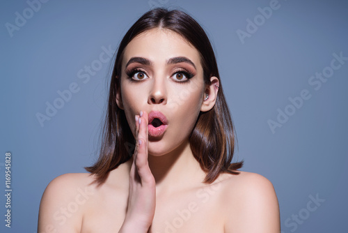 Close up photo of impressed woman isolated over studio background. Portrait of an excited young girl looking in excitement. Young woman shocked with surprise expression, amazed and excited face. photo