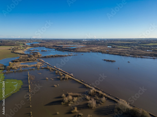 Aerial drone view of flooding from heavy rainfall causes road closures as nearby Fairburn Ings nature reserve floods in West Yorkshire. Agricultural fields and local businesses flooded. photo