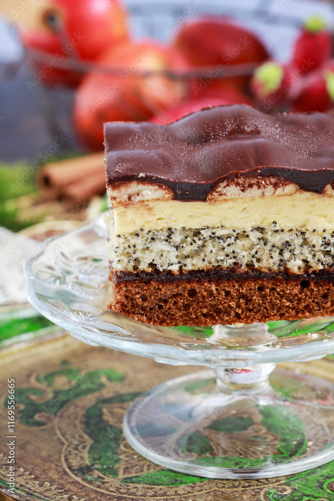 Multi layer cake with vanilla, poppy seed and chocolate among Christmas decorations.