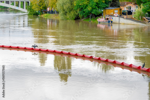 Paris, France Inflatable barrier to block pollution on a Marna river. View on a peer with houseboats. photo