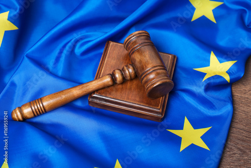 Judge's gavel and flag of European Union on wooden table photo