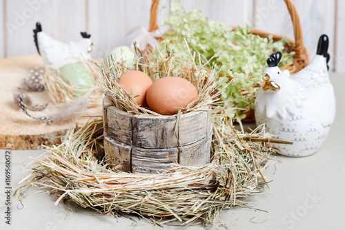Obraz na płótnie Cute Easter decorations with ceramic hen figurines, eggs and green flowers. w salonie