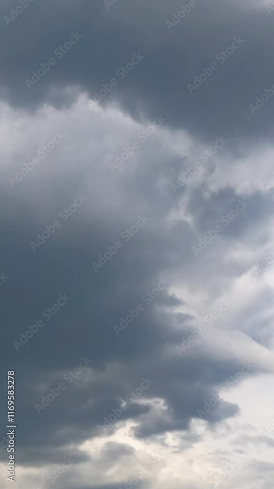 Stormy grey clouds accumulating in the atmosphere. Cumulus cloudscape formation in the sky from low angle view. Timelapse. Vertical video Stormy grey clouds accumulating in the atmosphere. Cumulus cloudscape formation in the sky from low angle view. Timelapse. Vertical video