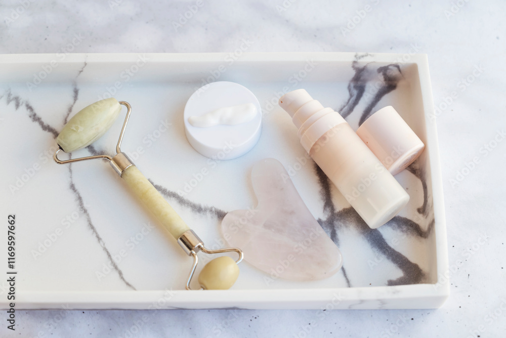 Fototapeta premium Anti-Age Face Cream and Jade Roller in Marble Plate