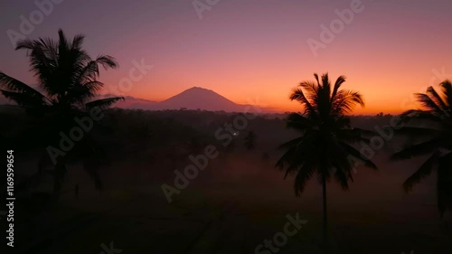 Beautiful sunrise scenery in Bali covered with mountains and mist aerial drone shot, Indonesia