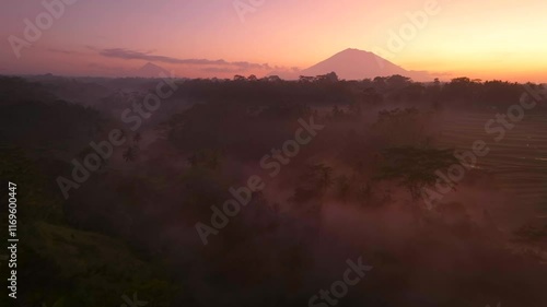 Beautiful sunrise scenery in Bali covered with mountains and mist aerial drone shot, Indonesia