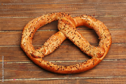 german pretzel with sesame seeds on wooden background photo