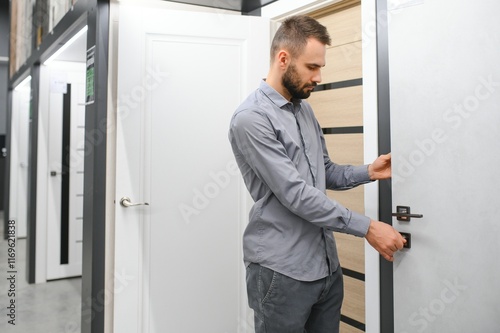 A man chooses doors in a hardware store for his apartment photo