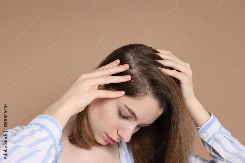 Girl with hair loss problem on dark beige background Girl with hair loss problem on dark beige background