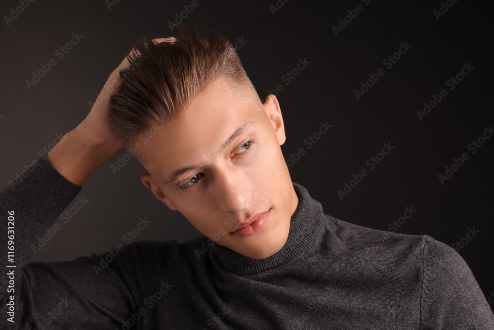 Confident young man with stylish haircut on black background Confident young man with stylish haircut on black background