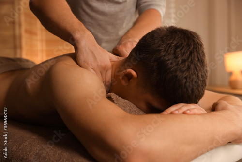 Massage therapist working with patient in clinic, closeup