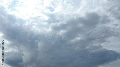 Cloudiness determines weather and climate, prevents both the cooling of the Earth's surface and its heating. Rainy heavy clouds background. Clouds are floating across the sky, rain is gathering