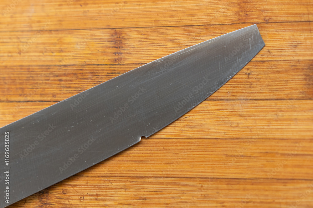 The Broken Kitchen knife on Wooden Cutting Board close up. Selective focus,