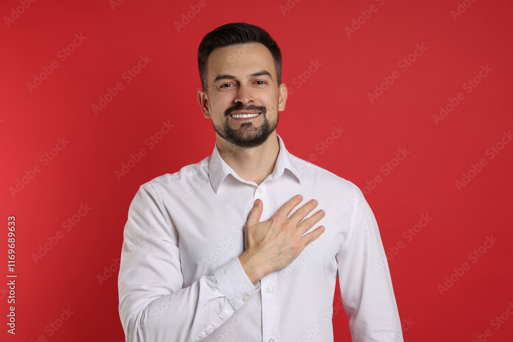 Man making promise on red background. Oath gesture Man making promise on red background. Oath gesture